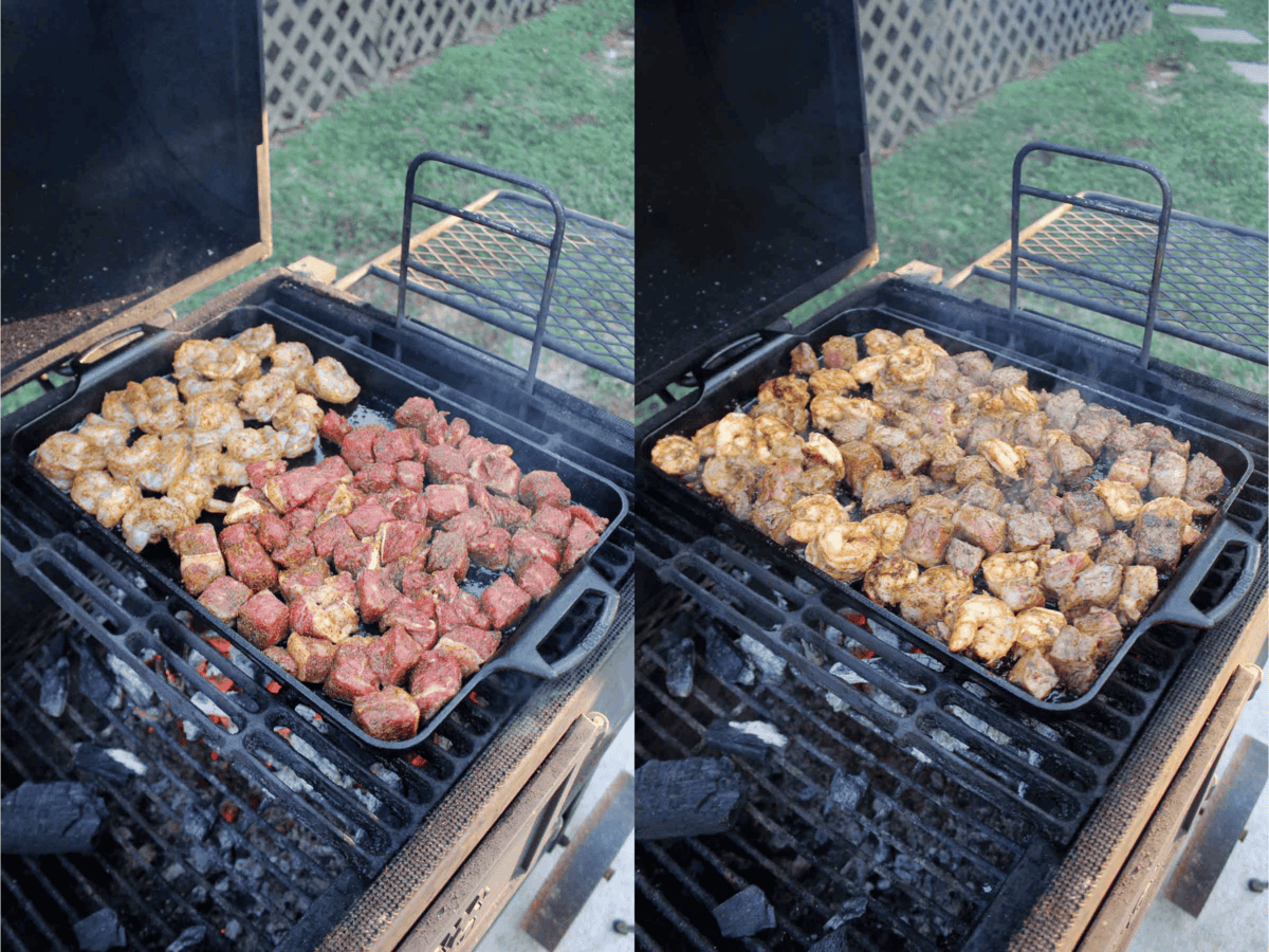 The steak and shrimp on cooking on the grill.