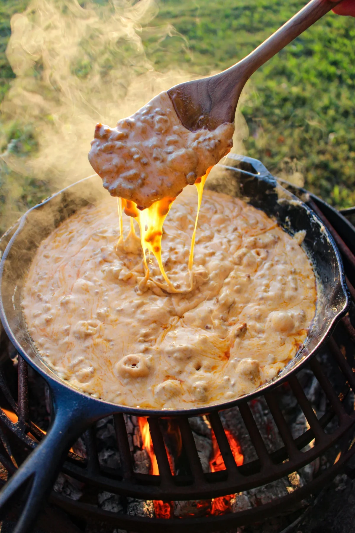 Mixing together the choriqueso and showing the cheese dripping off a spoon.