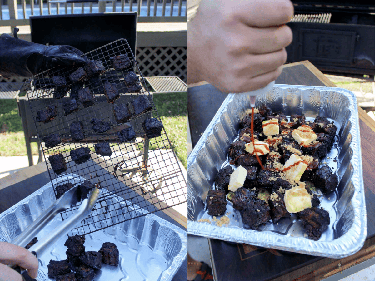 Moving pork belly cubes from the grill into a foil pan for the crutch braising, with butter cubes on top of the pork belly