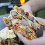 The Steak Fajita Quesadilla is cut in half so that Derek can show off the delicious ingredients: steak, veggies, and lots of cheese.