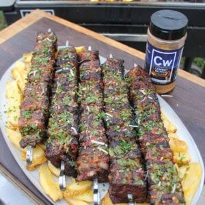 Steak and Bacon Skewers are a creative way to enjoy a steak dinner with some tasty French Fries.