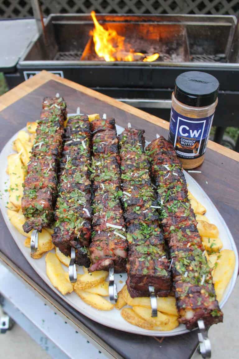 Steak and Bacon Skewers are a creative way to enjoy a steak dinner with some tasty French Fries.