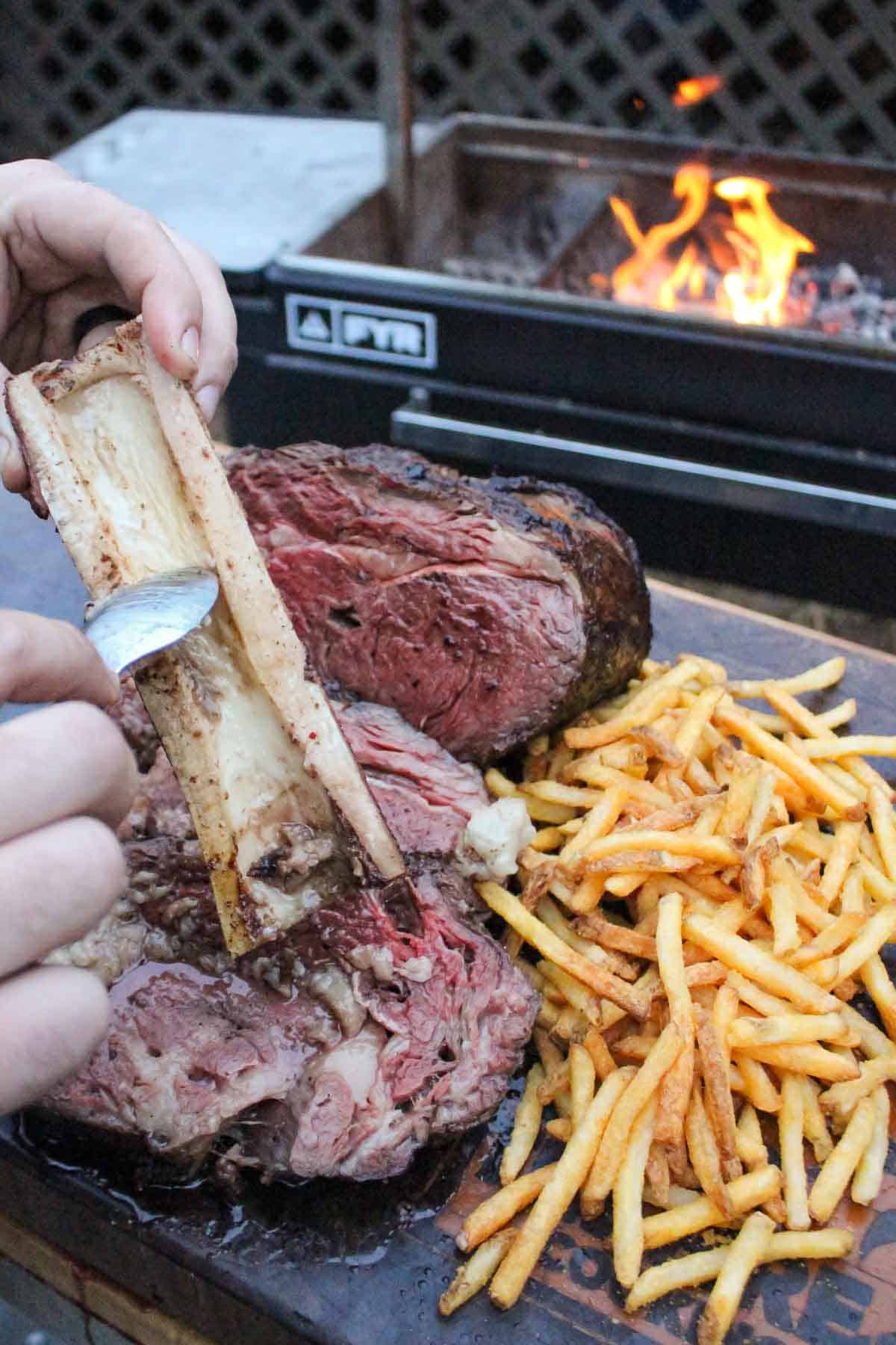 Derek Wolf adds the flavorful bone barrow to the beef slices for added flavor and moisture.