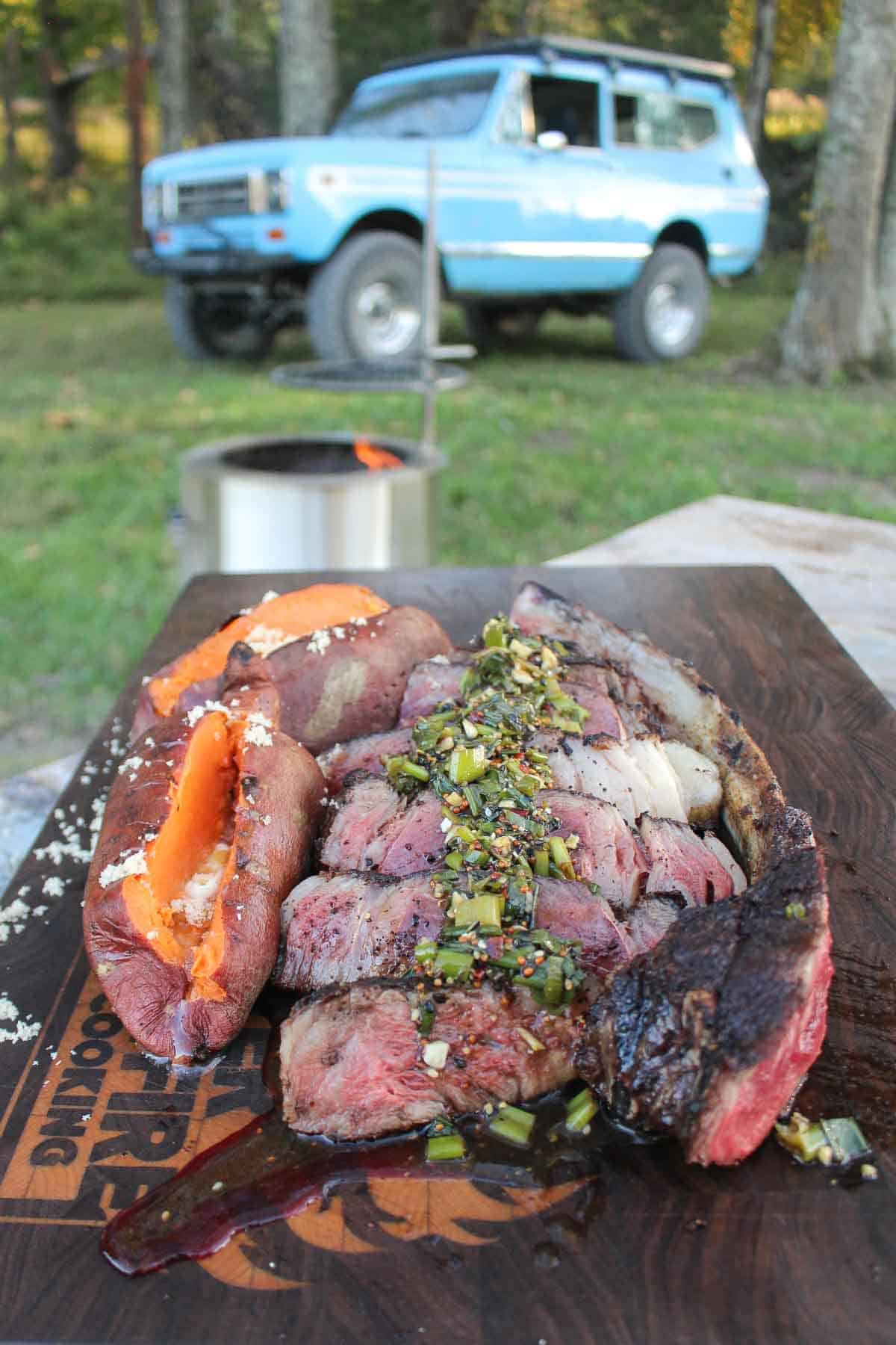 Learn how to grill a tomahawk steak recipe through this easy recipe, Grilled Steak with Charred Scallion Sauce and sweet potatoes. 