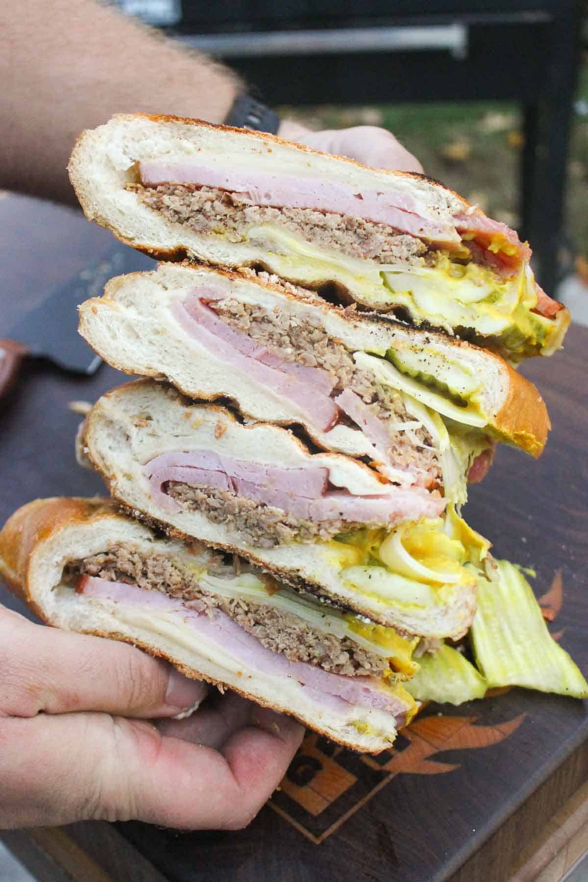 Holding the sliced sandwiches up to the camera.