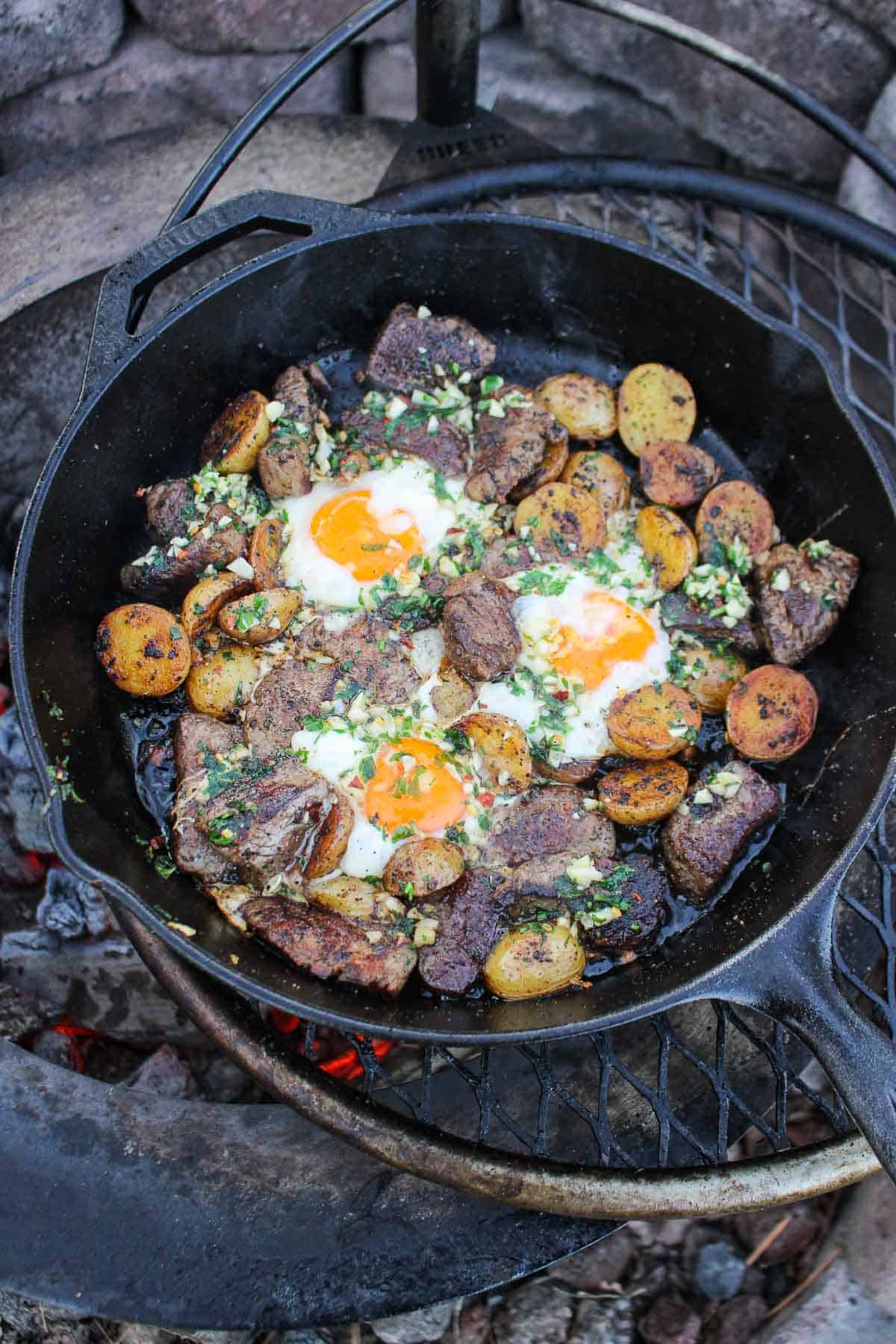 Steak, potatoes and eggs all cooked together in a skillet