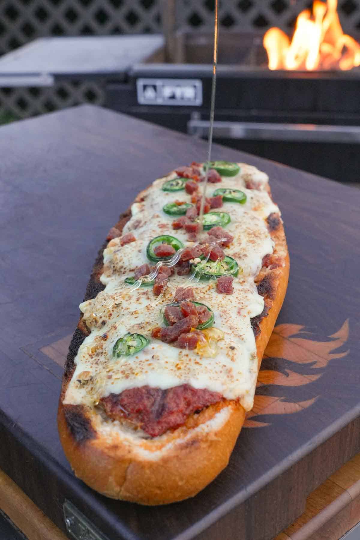 Honey is drizzled onto the Jalapeno Popper Bread after it's ready.