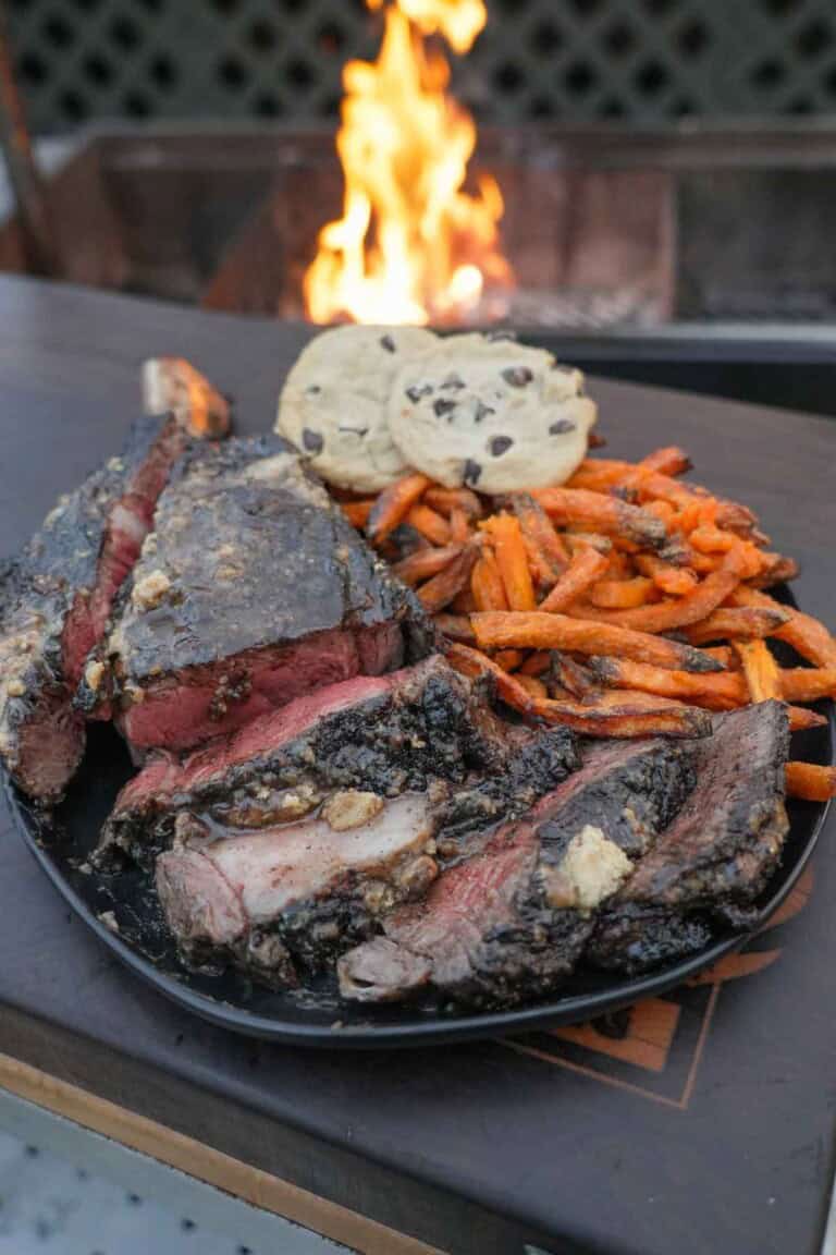 The Coffee Crusted Steak is plated up with sweet potato fries and ready to enjoy.