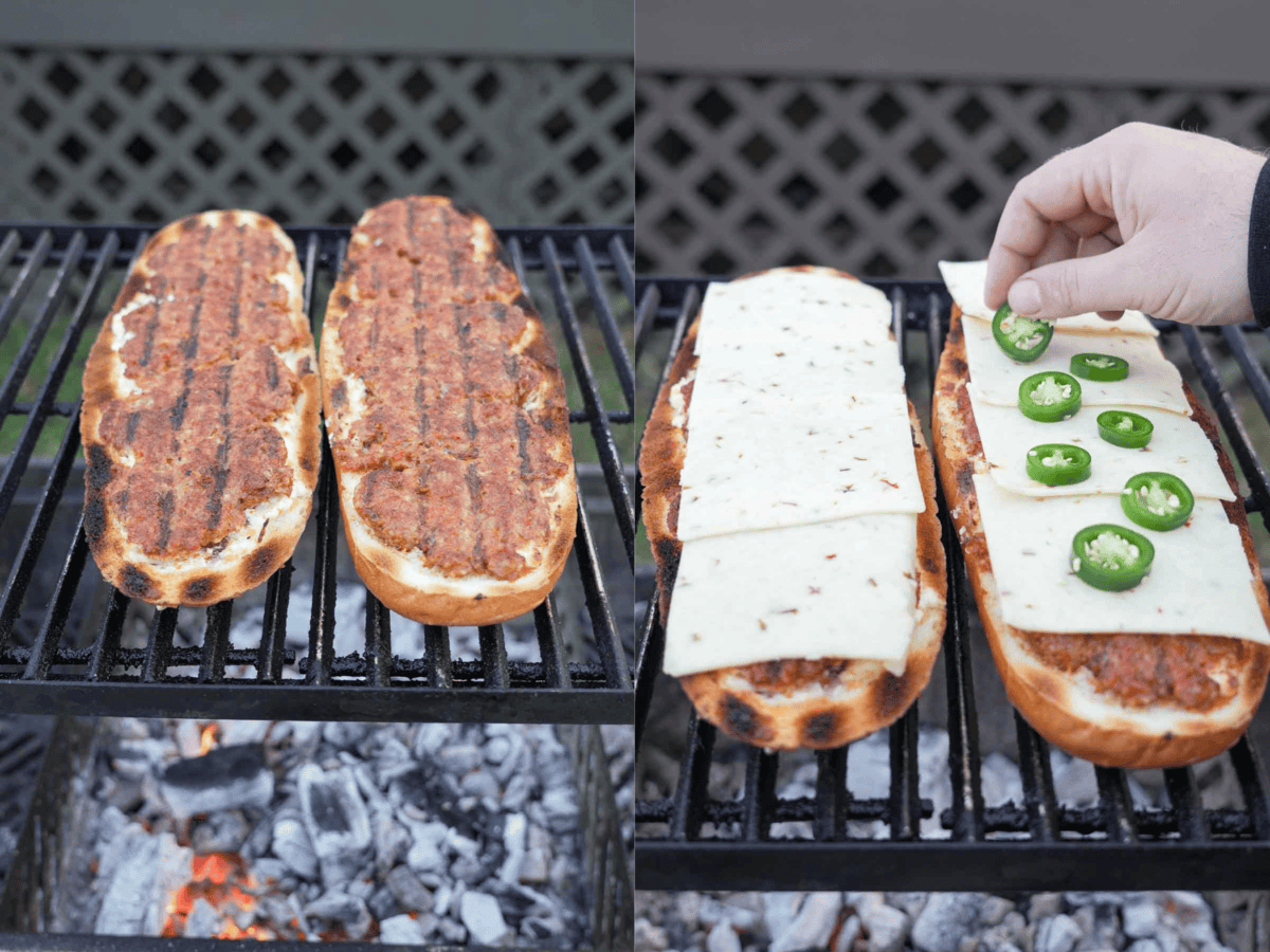 The stuffed bread is laid out on the grill and covered in slices of cheese and jalapenos.