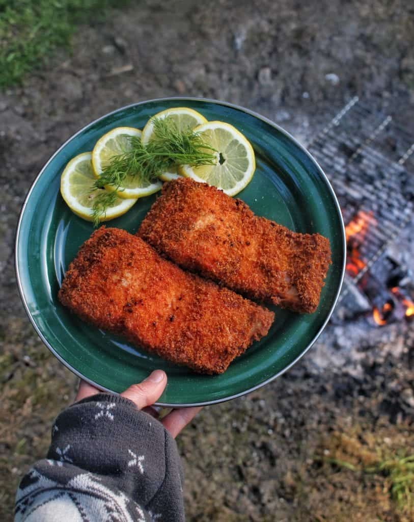 Two salmon filets, breaded and fried over the grill.