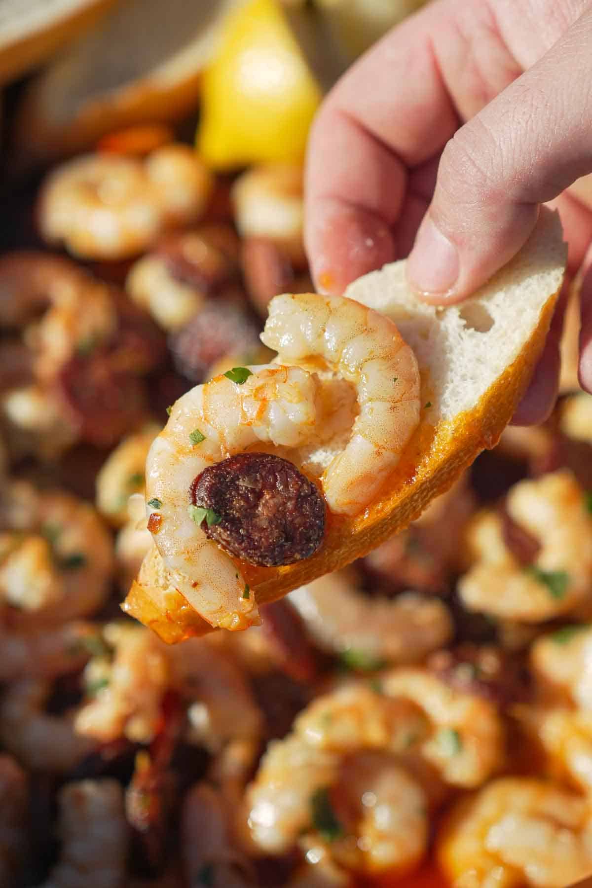 Chorizo Garlic Shrimp is scooped up on some crusty bread for the perfec rustic bite.