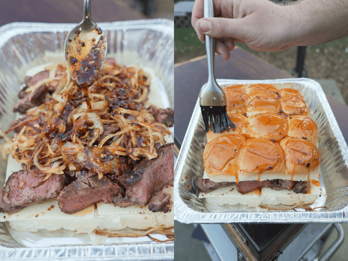 Assembling the hot honey steak sliders with the mozzarella, steak and crispy onions, then brushing the top with hot honey butter