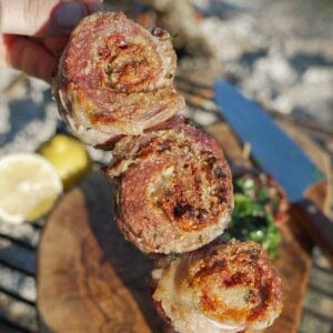 A line of three pork pinwheels, made with secreto steak and stuffed with jamon and Manchego cheese