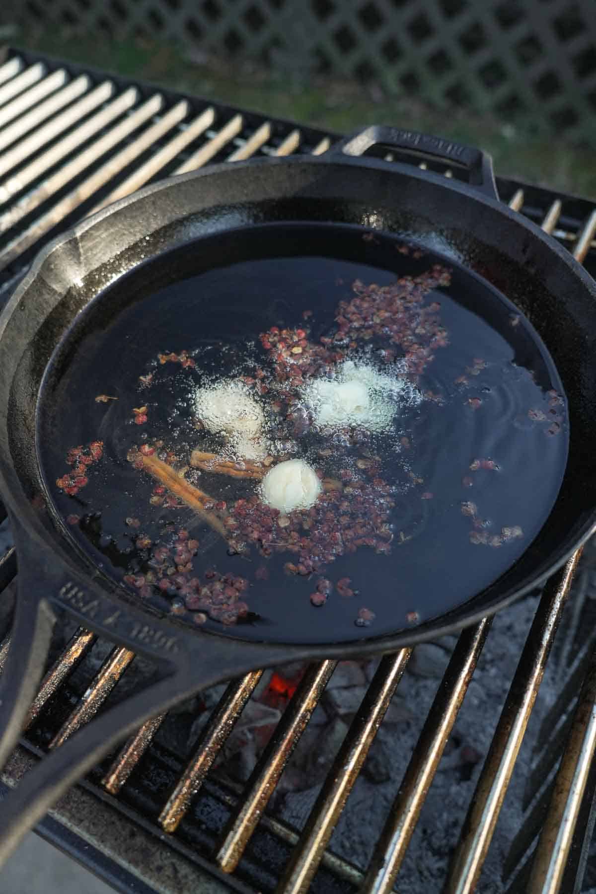 The steak is seasoned and the hot chili oil is infused with tons of flavor in the cast iron griddle pan.