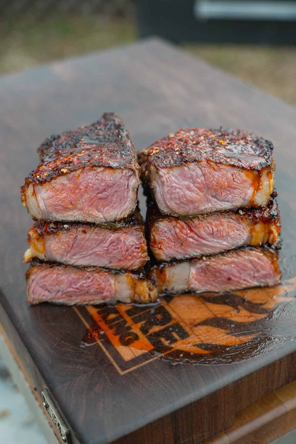 The juicy steaks are sliced in half and we can see that they are medium rare, nice and pink and ready for the tacos.