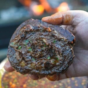 Birria Steak Pinwheels are in Derek's hands, looking perfectly cooked and perfectly ready to eat.