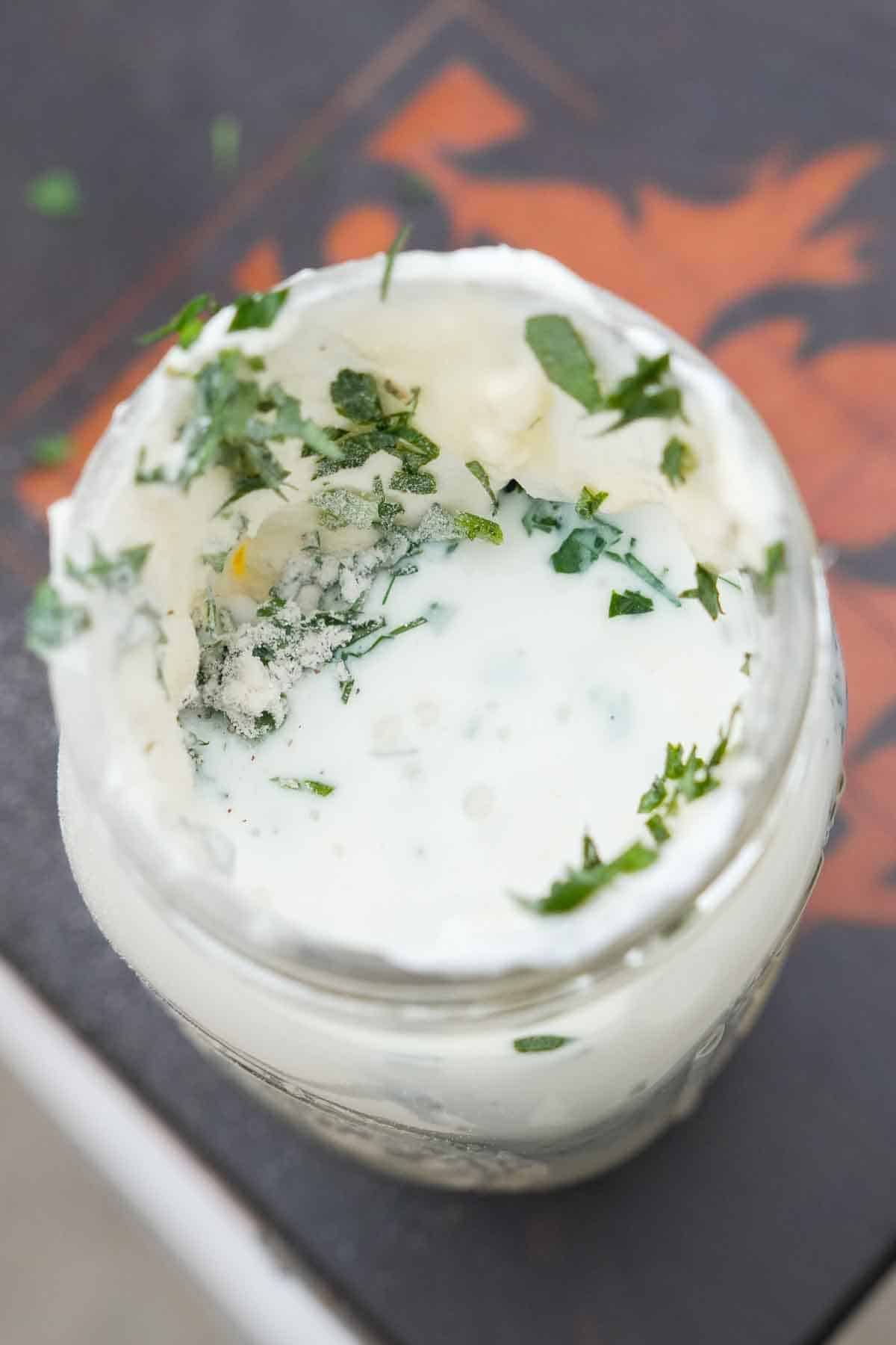 Homemade ranch dressing ingredients mixed together in a mason jar