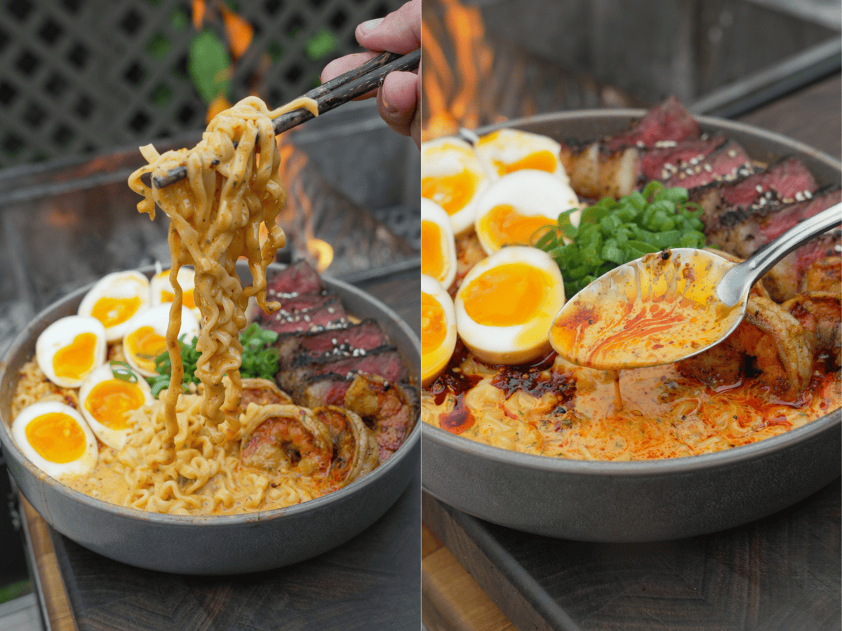 A hand holding chopsticks and pulling noodles out of a bowl of surf and turf ramen, and using a spoon to display the broth