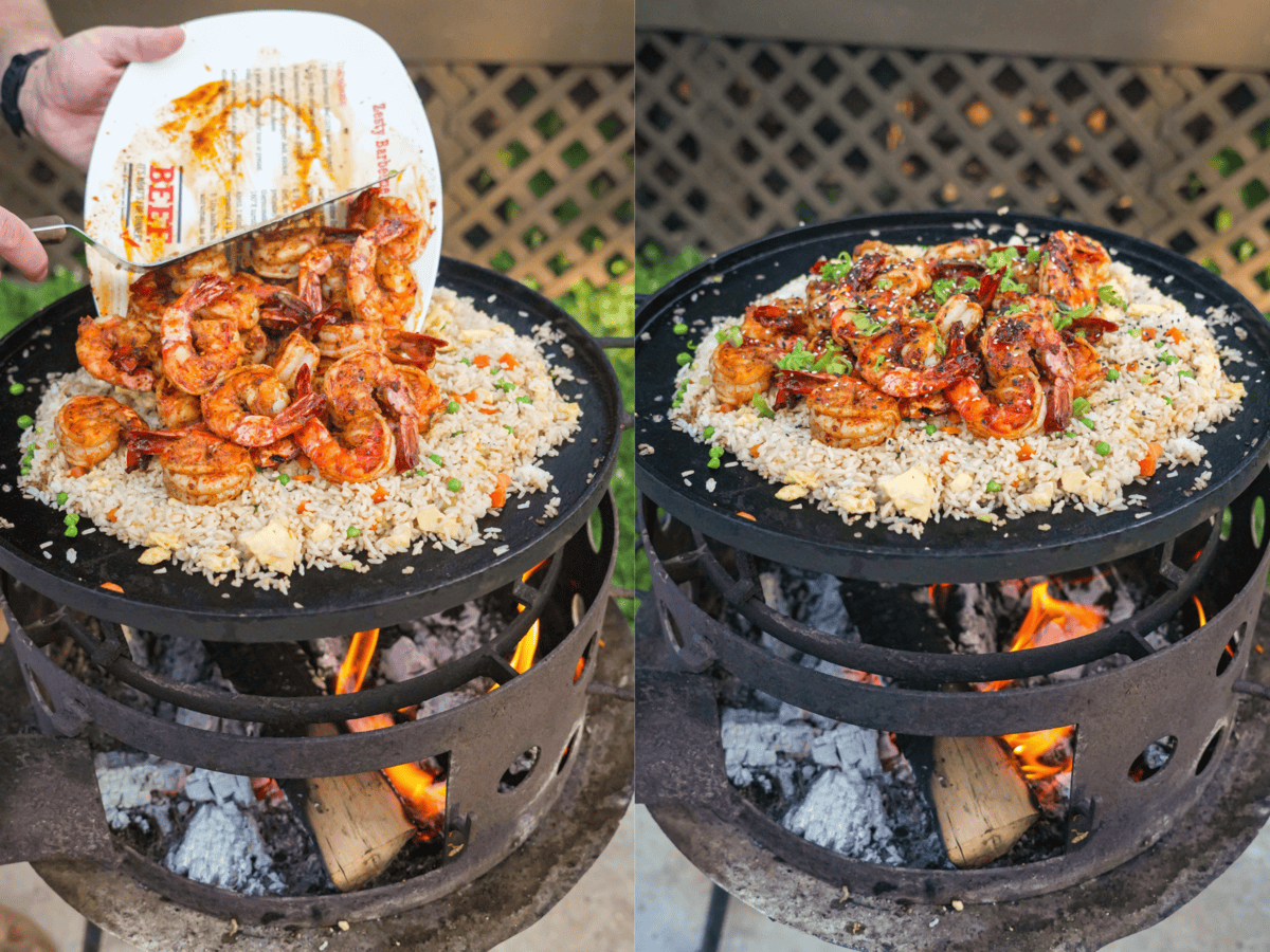 Pouring shrimp from a plate onto cooked fried rice in a skillet and adding sesame seeds, scallion greens as garnishes