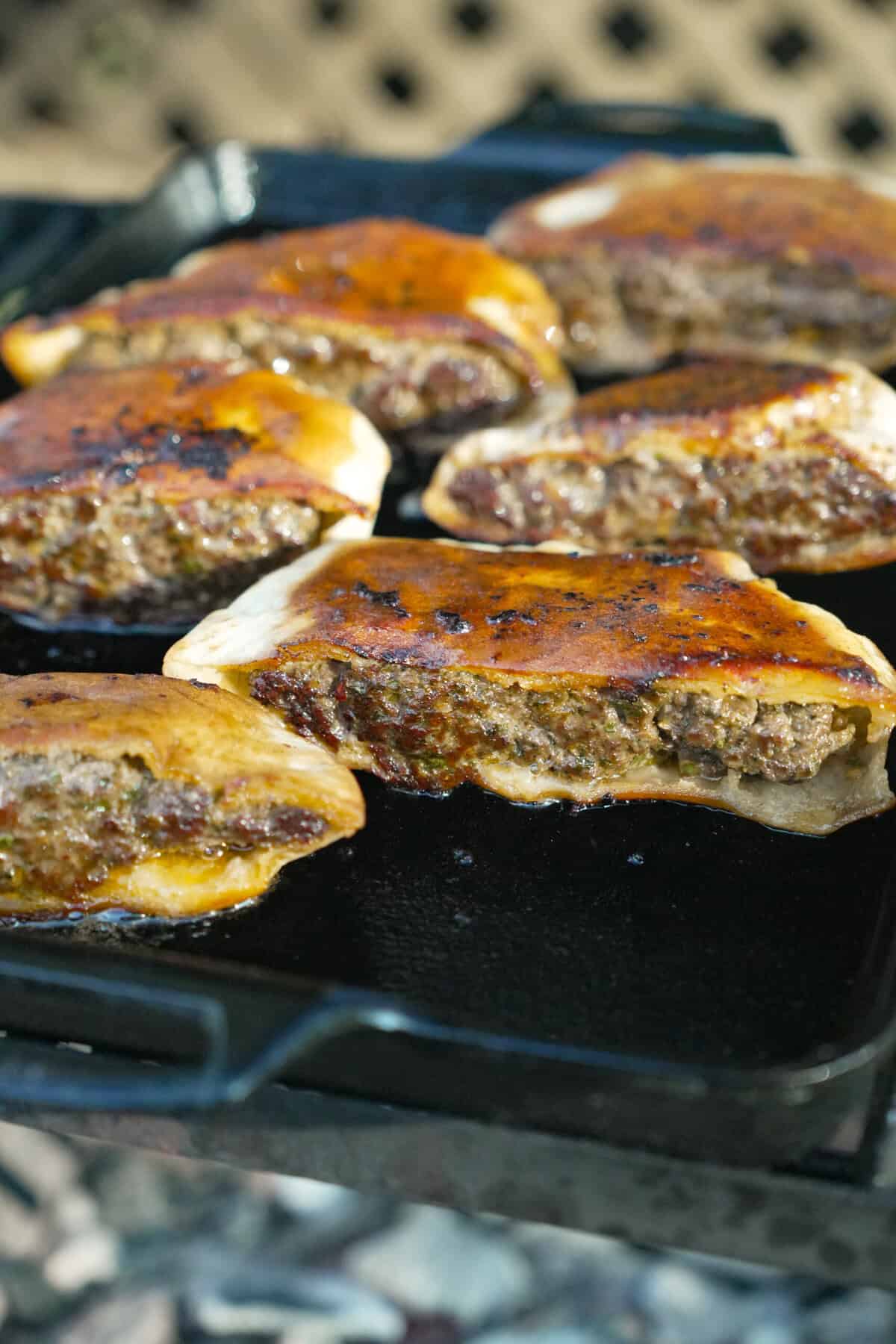 The stuffed pita halves after flipping look melty and crispy and ready to eat.