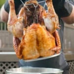 The Deep Fried Turkey is pulled out of the hot oil by Derek Wolf.