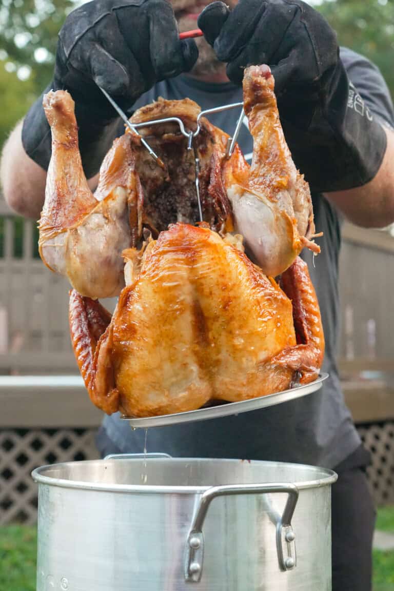 The Deep Fried Turkey is pulled out of the hot oil by Derek Wolf.