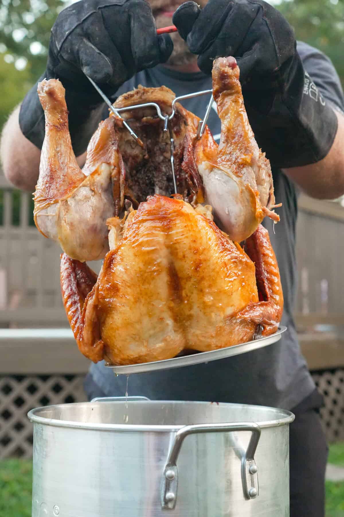 The Deep Fried Turkey is pulled out of the hot oil by Derek Wolf. 