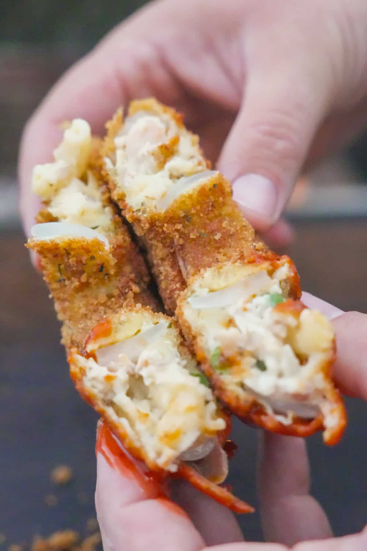 A view of the crispy Thanksgiving Onion Ring split in half, bursting with Thanksgiving leftovers.