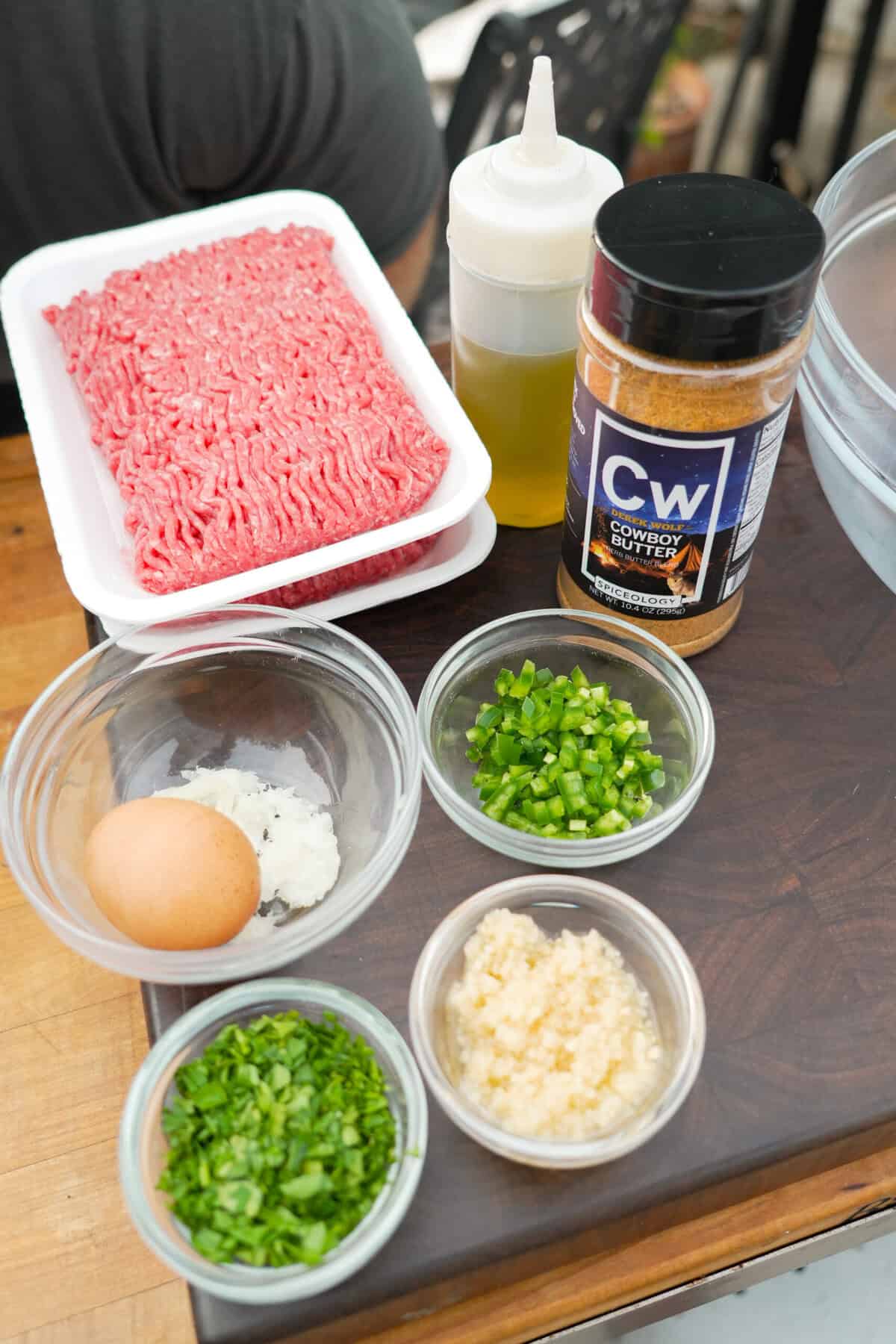Ground beef, egg, onion, jalapeño, Cowboy Butter Seasoning arranged on a platter