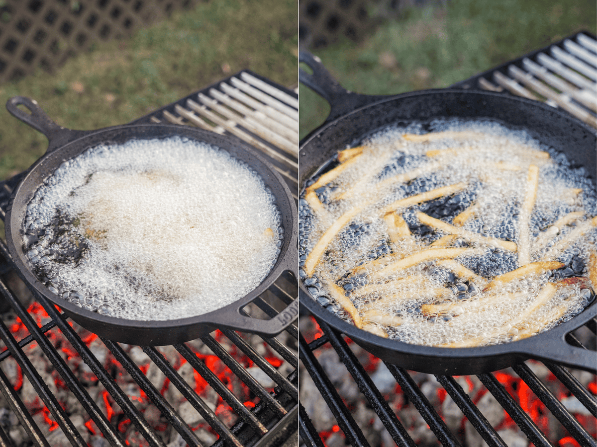 French fries are cooking in a cast iron skillet sitting on top of the grill.