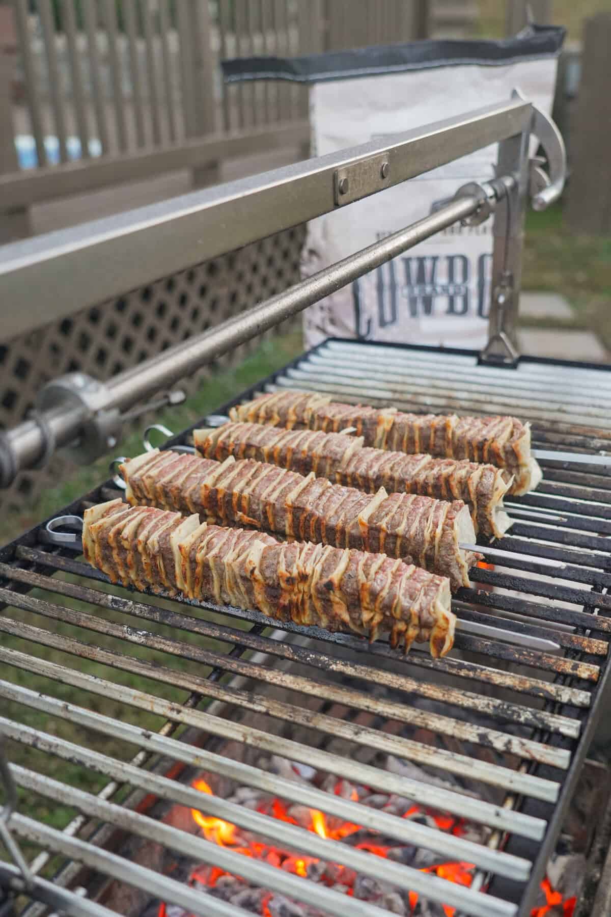 The kebabs cook on the grill, getting juicy and more freakin' delicious by the second.