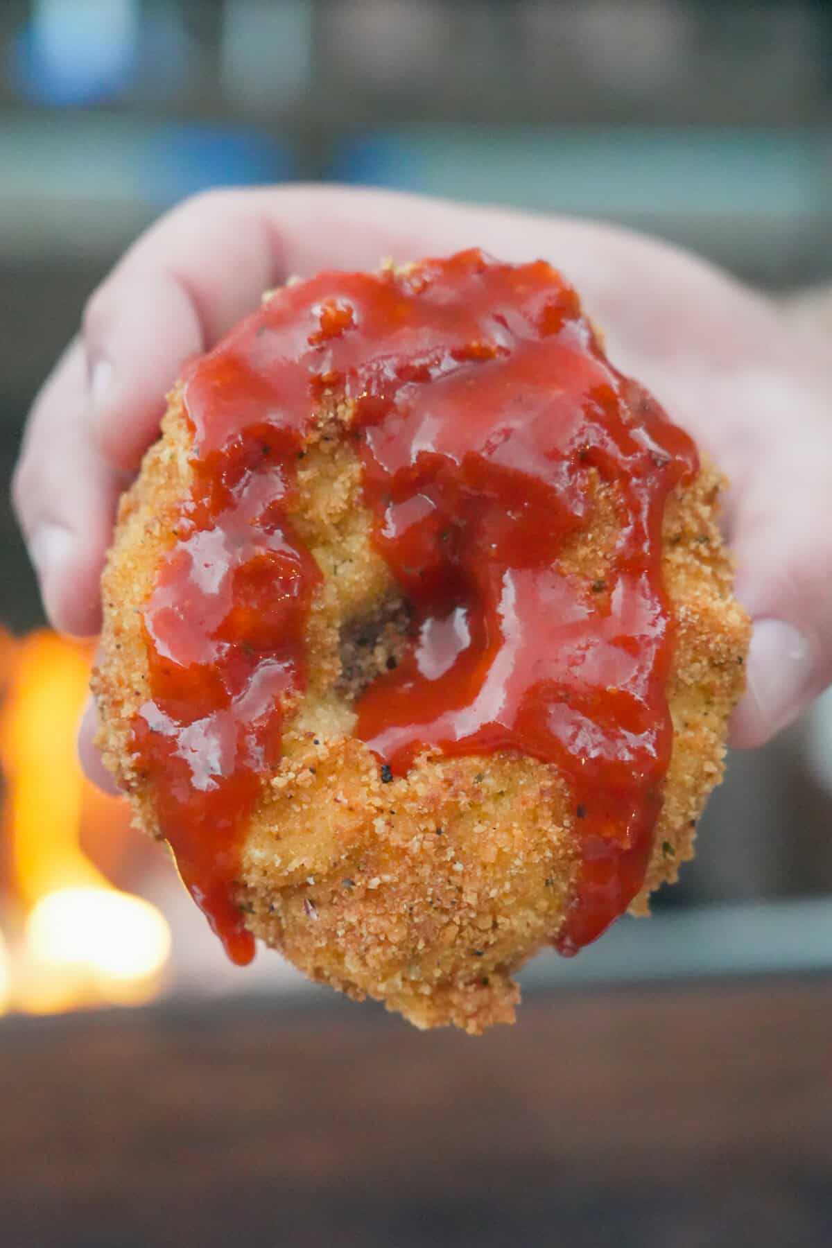 The Thanksgiving Onion Ring is dipped in a fire sauce before digging in.