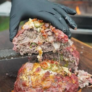 Cutting open a slice of Texas Twinkie meatloaf to show the ingredients &mdash; cheese, brisket, bacon bits and jalape&ntilde;os &mdash; stuffed inside