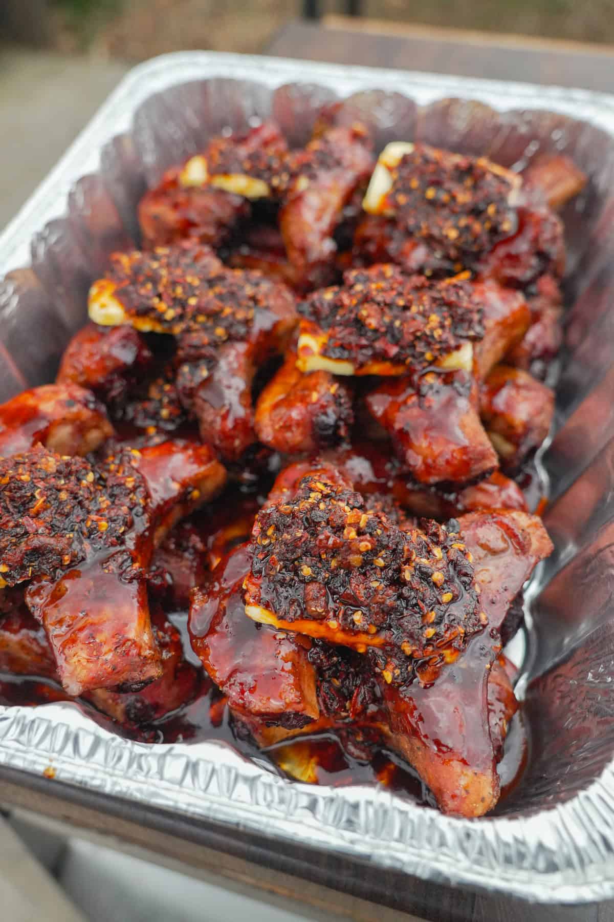 A progress shot of the honey chili oil party ribs halfway through the cook, with chili oil added to the crutch