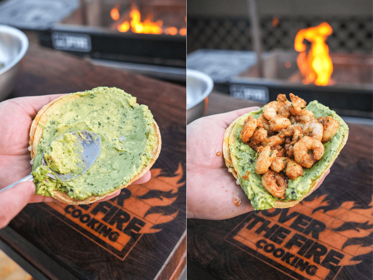 Derek Wolf holding a tortilla with guacamole, then adding seasoned shrimp to it to assemble the chipotle shrimp taco