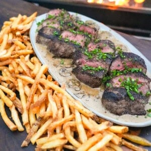 A finished platter of steak Diane with fries on the side