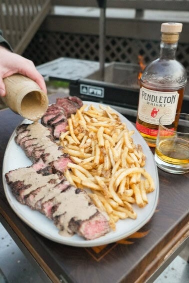 Steak au Poivre is an epic dish with perfectly cooked filets and crispy french fries and a creamy peppercorn sauce.