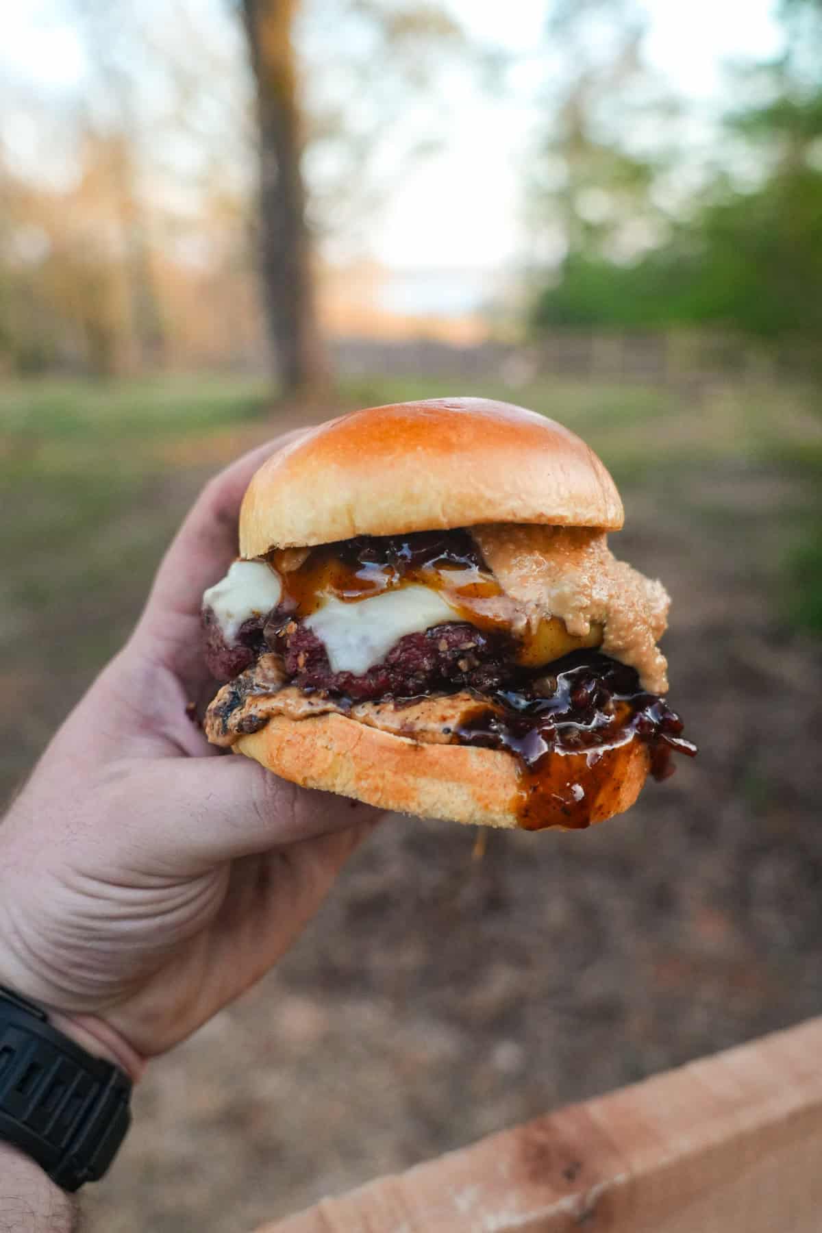 Whiskey Jam Bacon Burgers are comfort food at its finest. Peanut butter and bacon dripping out of the juicy burger with cheese is an experience you won't want to miss.
