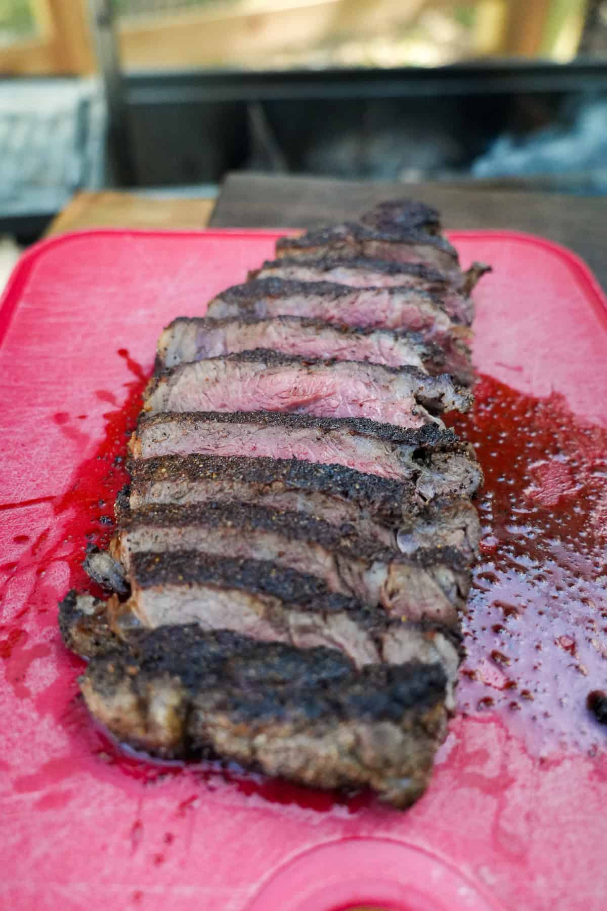 Cooked sliced steak on a cutting board