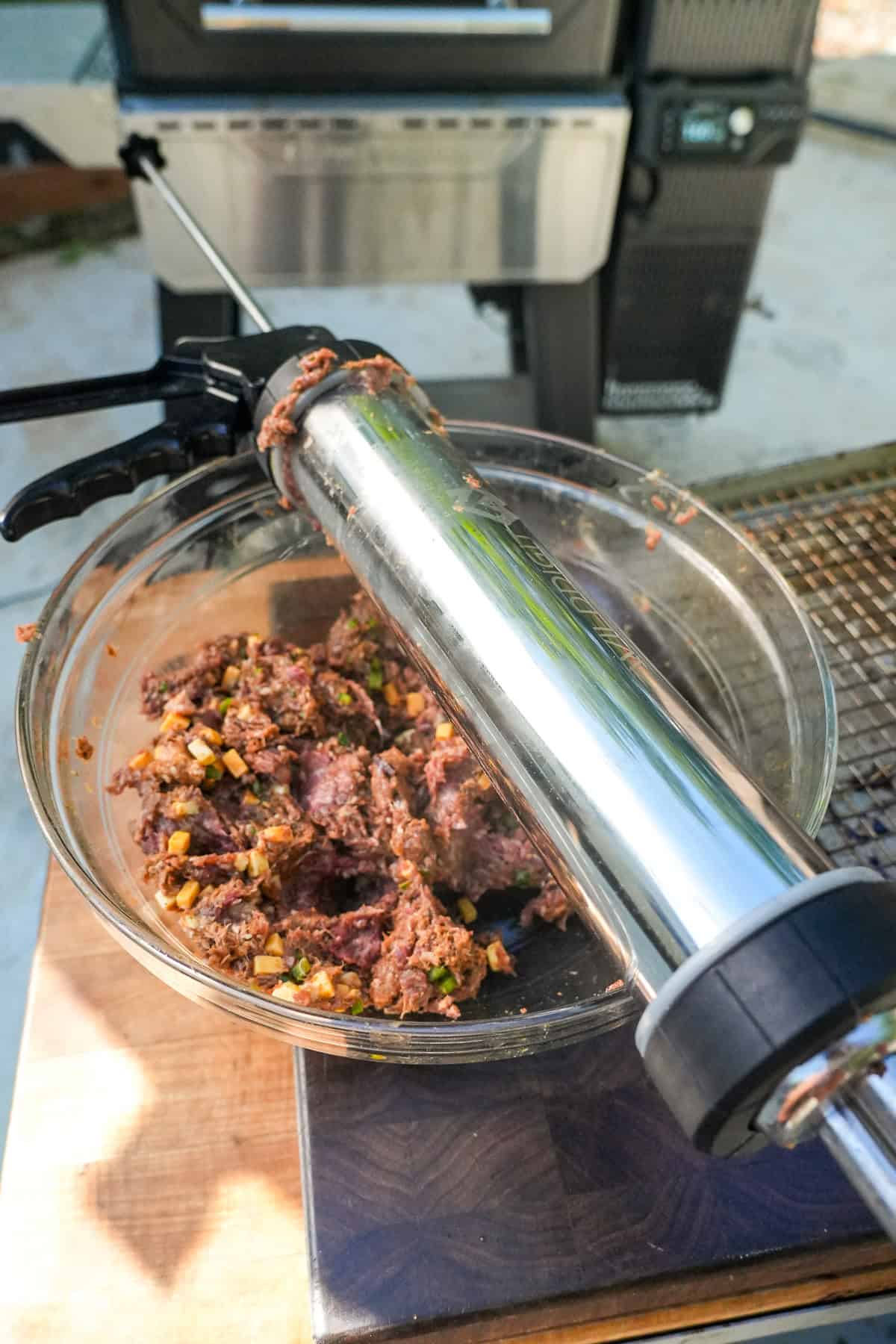 Loading beef mixture into a jerky gun