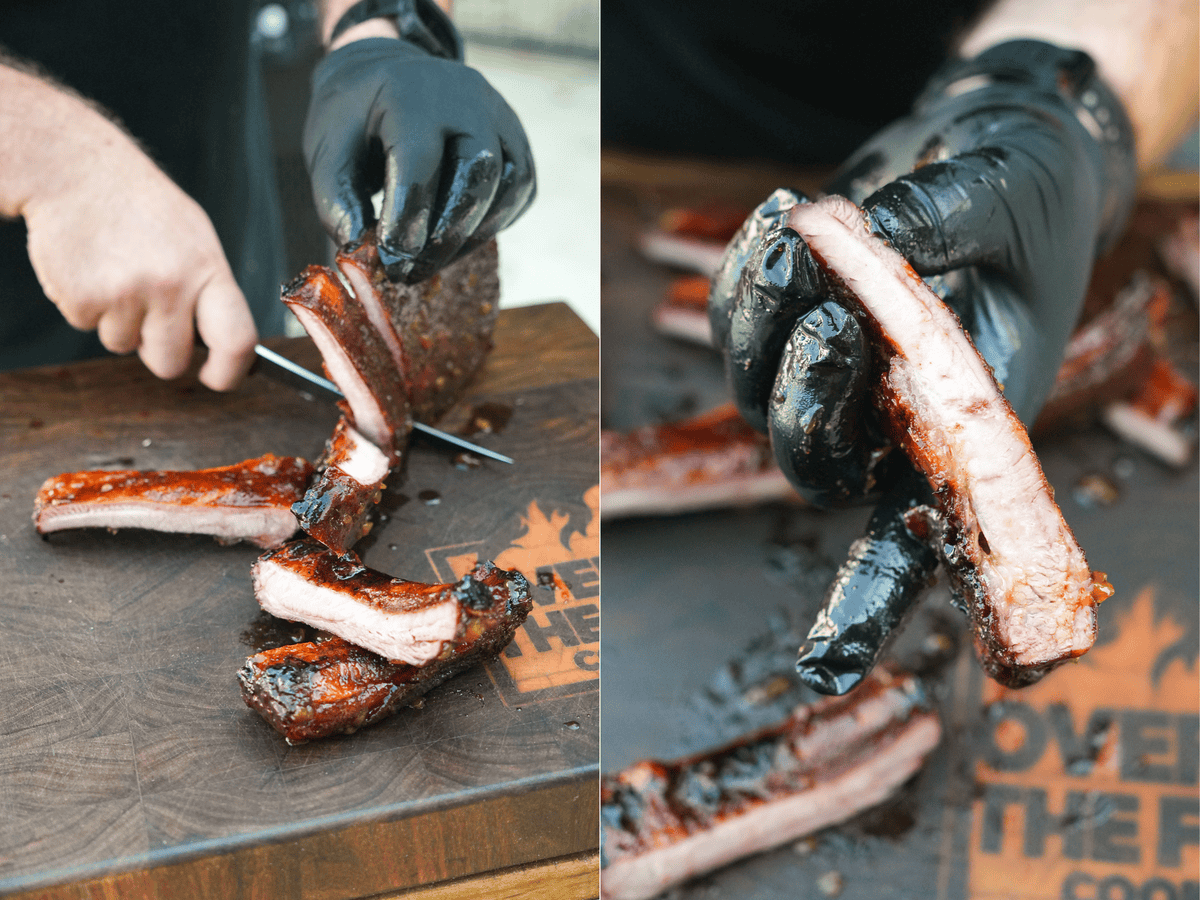 Derek Wolf slicing finished bourbon peach ribs before dipping in the glaze