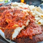 A close up of the Spicy Chicken Park, sliced into strips and served with pasta.