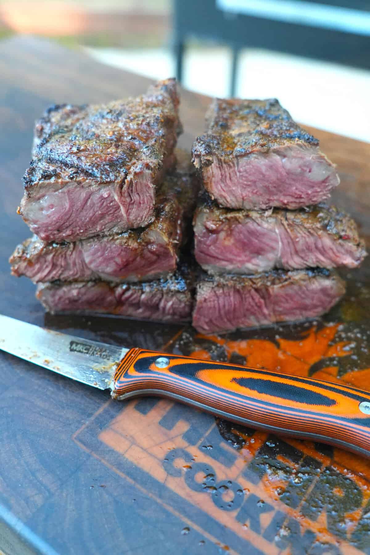 The perfectly cooked steak is sliced with a sharp knife and ready for serving to your hungry crew.
