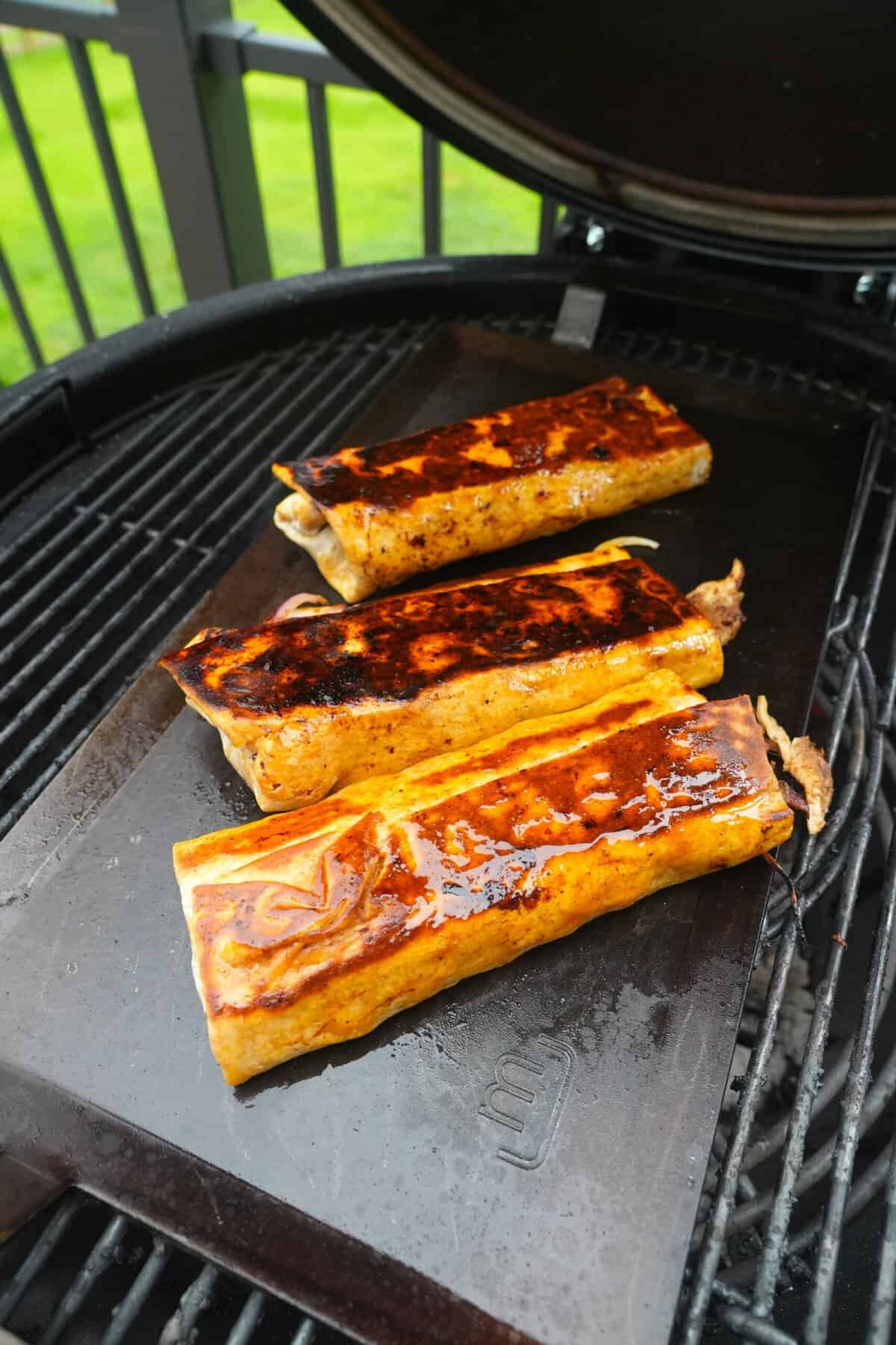 Searing crispy chicken shawarma in lavash bread on a grill