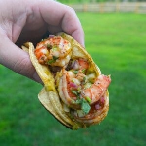 Derek Wolf holding up a finished dirty shrimp taco