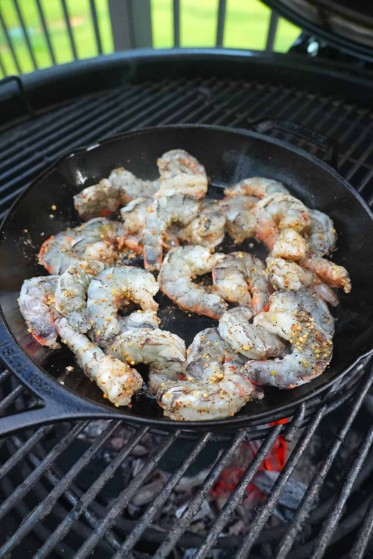 Searing shrimp in a cast iron skillet on the grill
