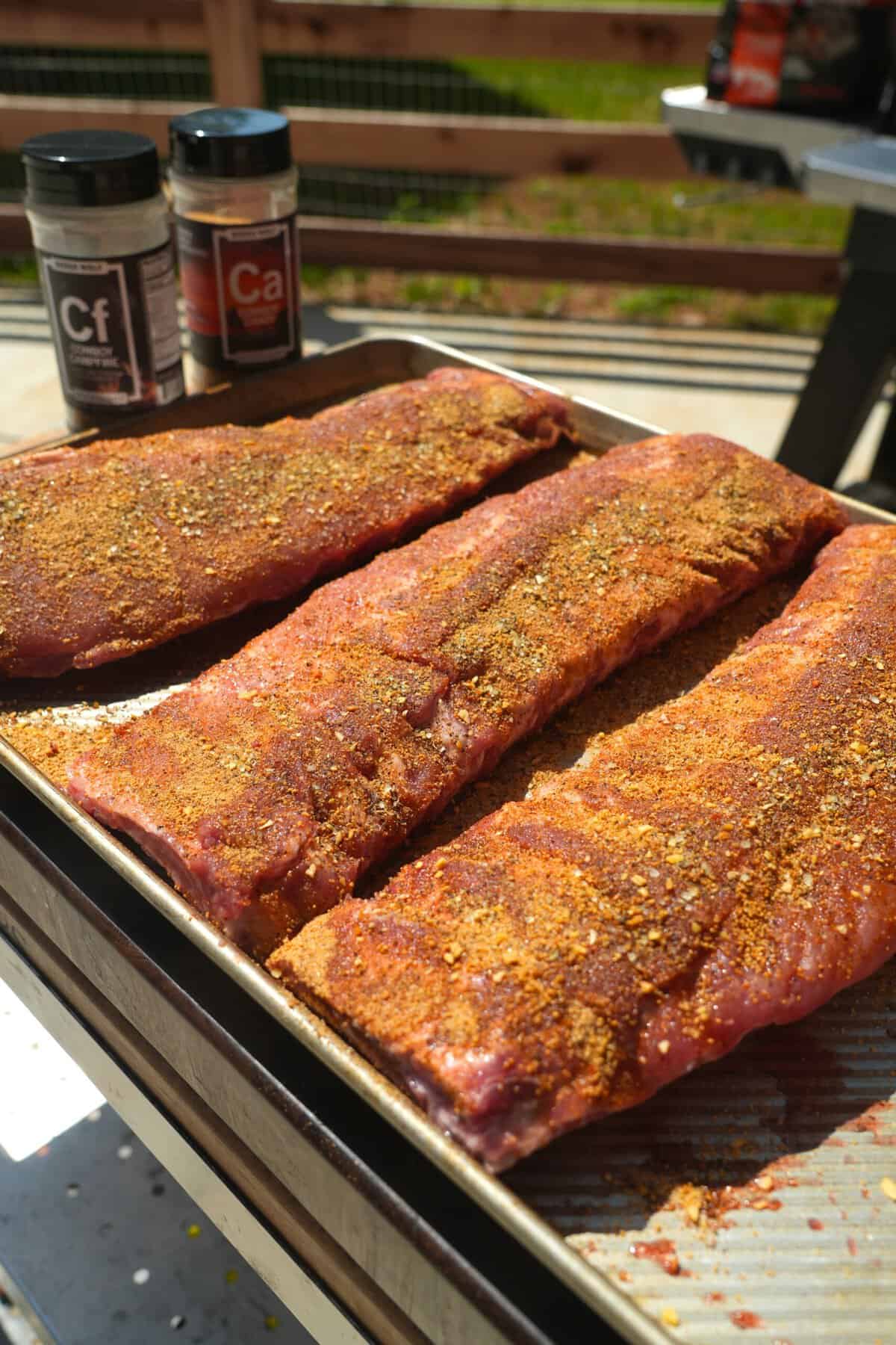 Seasoned pork ribs are ready for the smoker.