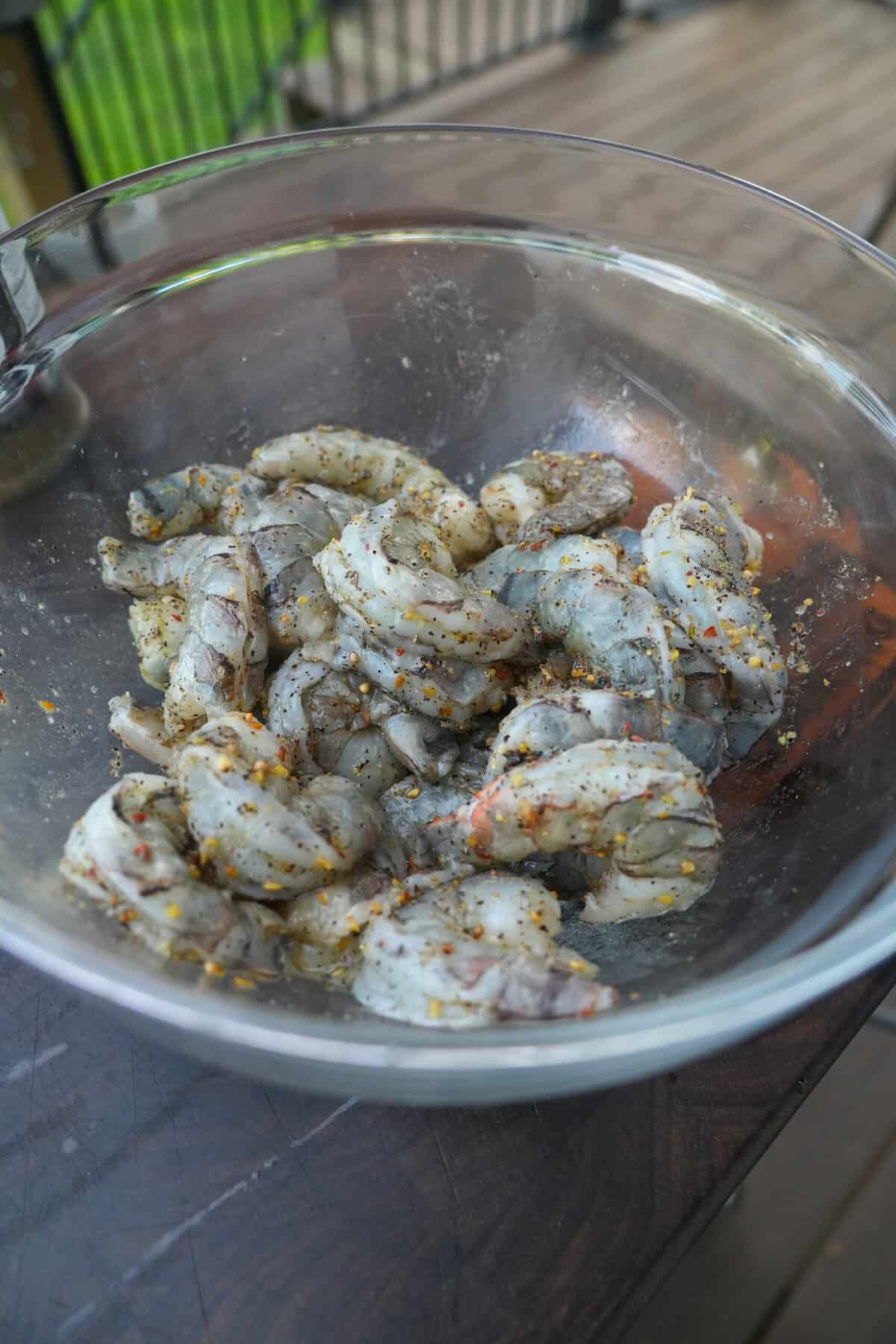 Tossing together raw shrimp with Cowboy Campfire in a bowl to make dirty shrimp tacos