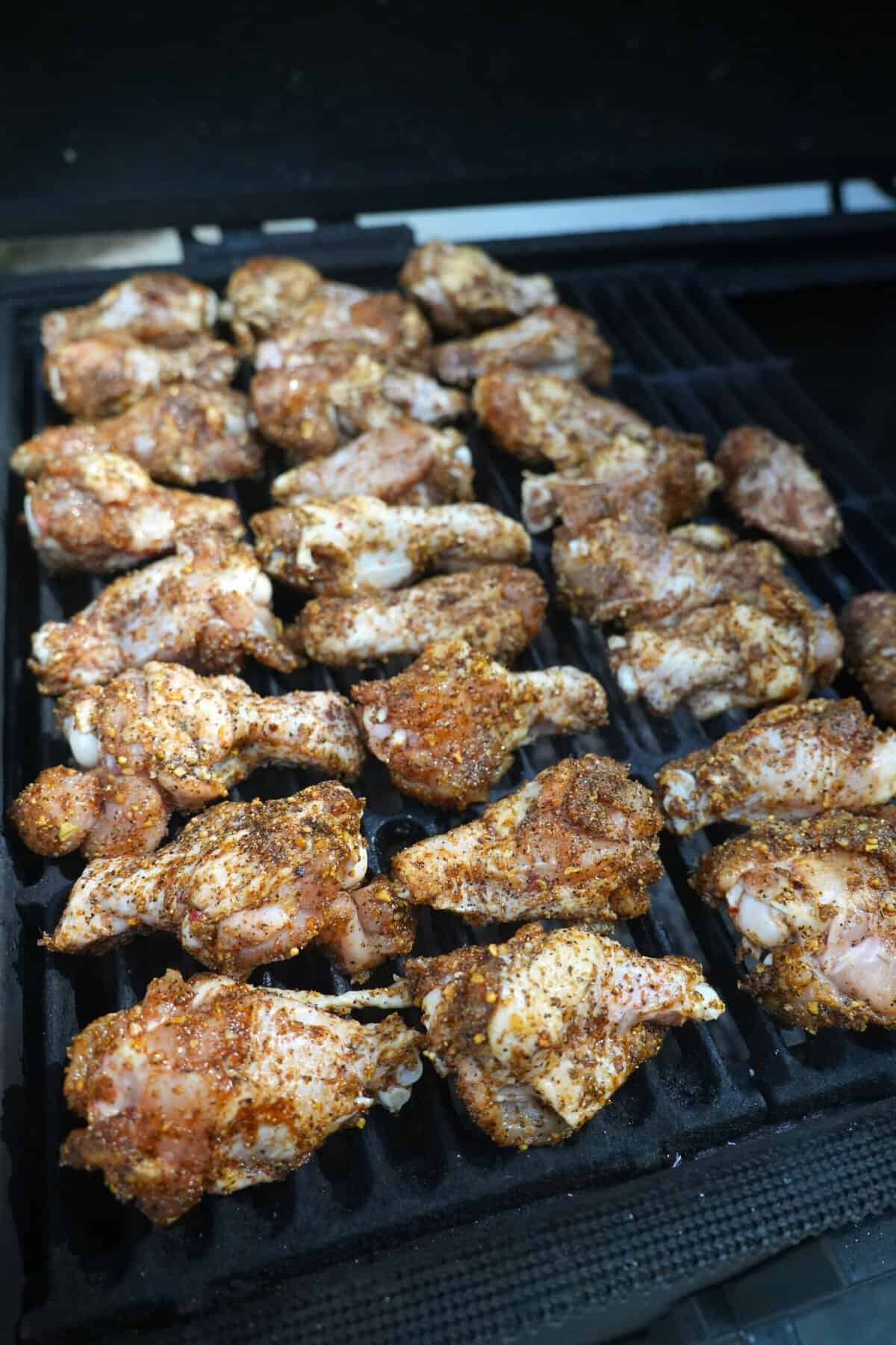 The wings are smoked to tender perfection on the outdoor grill.