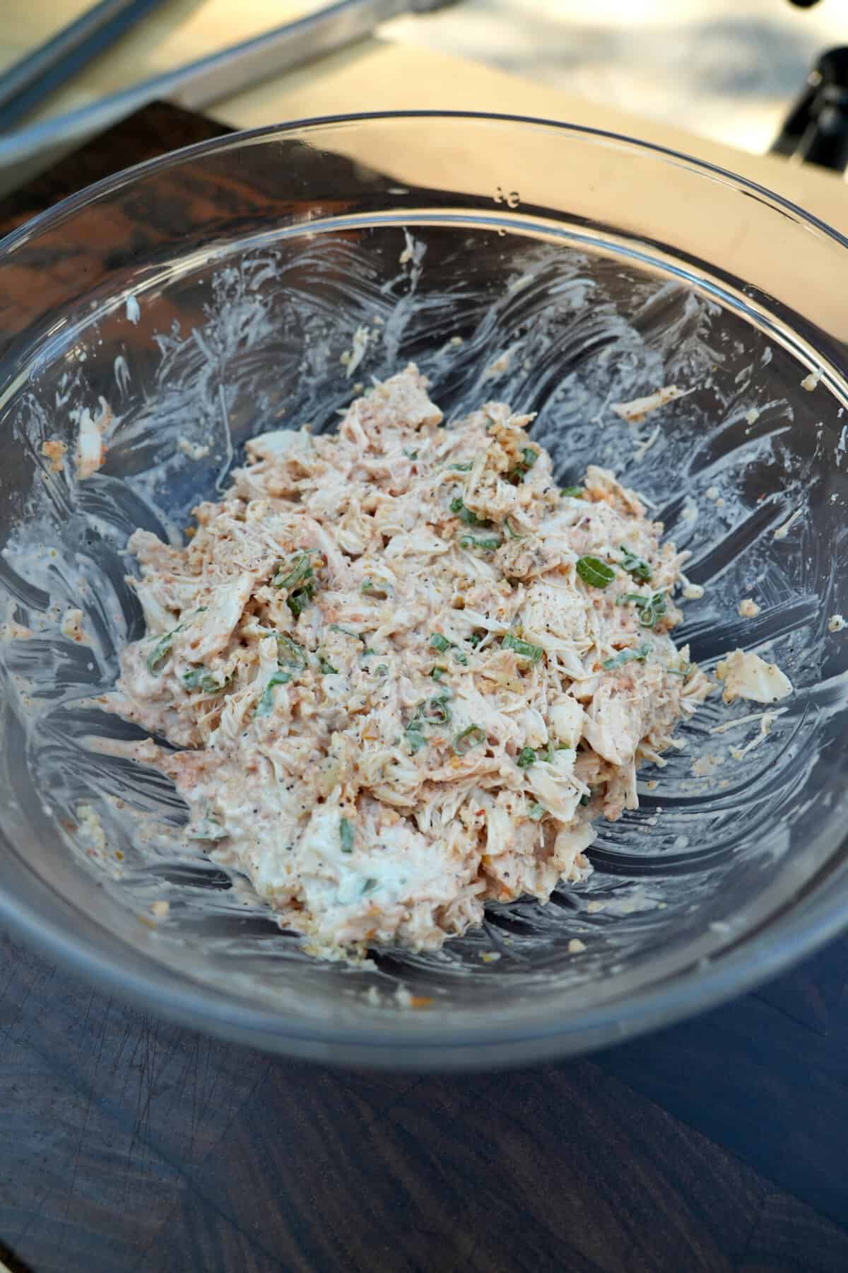 Mixing together filling for lobster stuffed egg rolls, with mayonnaise and panko breadcrumbs